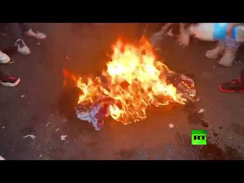 شاهد إحراق علمي إسرائيل وأمريكا وسط بغداد